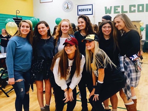 SENIORS CASSIDY ATCHISON and Ashley Drum pose with friends on National Signing Day.