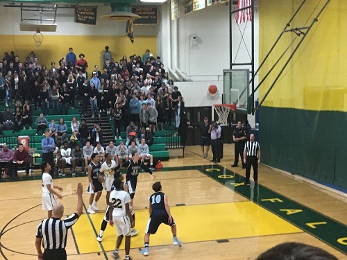 BOYS BASKETBALL WAITS for the basket.