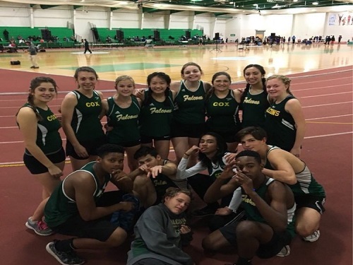 ATHLETES FROM THE girls and boys indoor track teams pose for a photo after their meet.