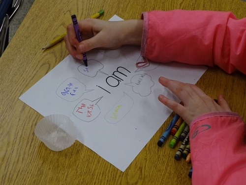 YOUNG GIRL CREATES motivational art at Beach Girls Rock.