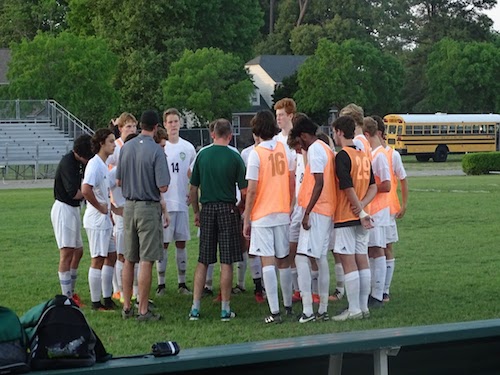 BOYS VARSITY SOCCER circles up for a team talk before the game.
