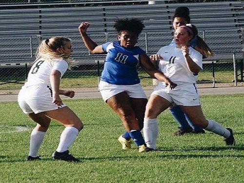 SENIOR OLIVIA MERKLINGER and teammate Adia Horvath battle a Green Run High School player in a recent game.