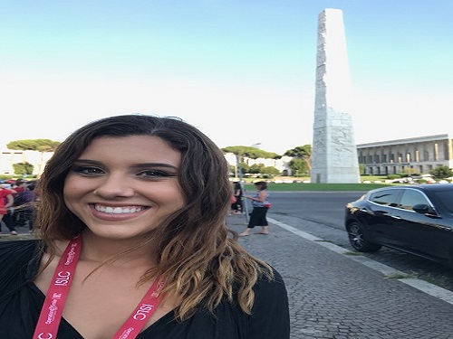 SENIOR SKYLAR MAILHES in front of an Italian sculpture waiting to go inside of an Operation Smile event. 