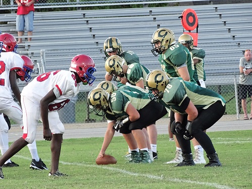 JUNIOR VARSITY FOOTBALL players get in position to make an offensive attack.