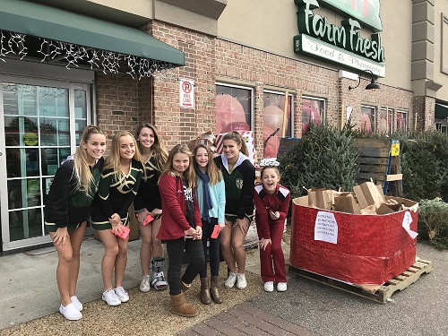 CHEERLEADERS FROM THE school and Great Neck Middle School combined efforts to collect items for families in need at the Farm Fresh off of Great Neck Rd. for the Farm Fresh Feed your Friends Food Drive initiative.