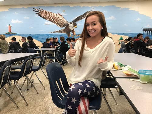 JUNIOR MADDIE THOMAS poses in red, white, and blue for spirit week.