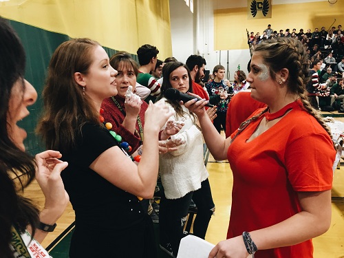 JUNIOR ABBEY FARO speaks to teacher Mrs.Paine during the pep rally.