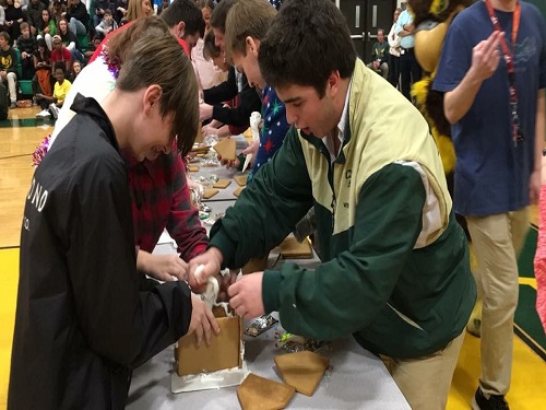 STUDENTS AND TEACHERS compete in a gingerbread house making competition.