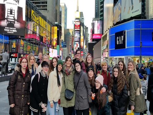 ART STUDENTS STAND in front of the Statue of Liberty while on their trip to New York. 
