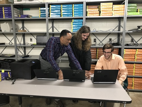 TECH SPECIALIST MR. Jeter works alongside Adavanced Technology Center interns seniors Alex Larkin and Noah Kantirakis.