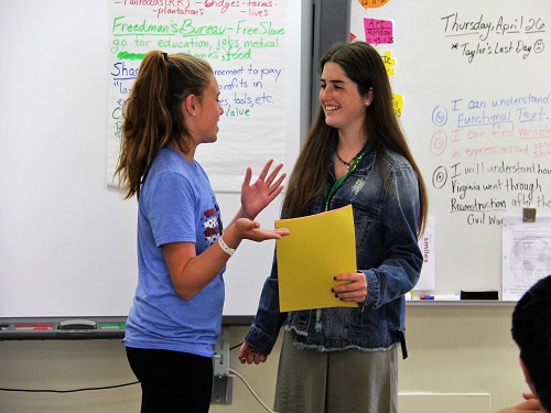 JUNIOR TAYLOR SCHOOLAR hands out an award to a student on her last day as a student teacher.