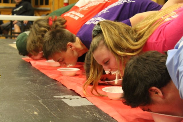 DELEGATES PARTICIPATE IN  a marshmallow eating contest.