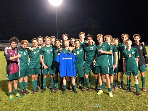 THE BOYS VARSITY team poses together as they celebrate their hard fought win over Princess Anne.