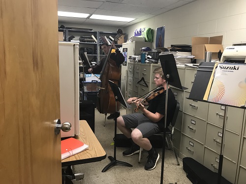 JUNIOR ELI DILLS practices the violin. in preparation for the upcoming orchestra concert. 