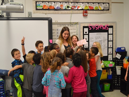 SENIOR ROBYN SANDERS was offered a future teaching contract with VBCPS upon completion of college.  Sanders is pictured at Thoroughgood Elementary with her internship class.