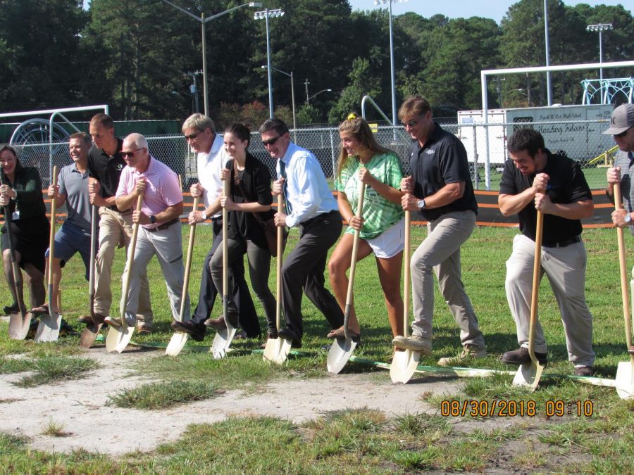 STUDENTS, STAFF, AND crew line up to break ground on the new project.