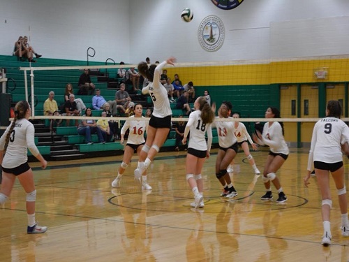 SENIOR MADDIE BUTKOVICH  leaps to spike the ball across the net.  It was a crucial point in the game.