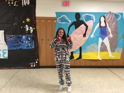 SOPHOMORE ALLIE DIBERARDINIS wears a festive onsie for pajama day. DIBERARDINIS posed in the Junior hallway, which won second place in the hallway decorating competition. 