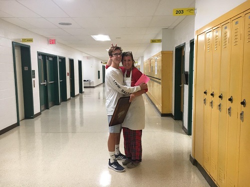 SOPHOMORE SPENCER GOODMAN meets with his mom, cooking teacher Mrs. Goodman, in the hallway during the first day of spirit week. Mrs. Goodman was dressed in her favorite pajamas and of course her apron!