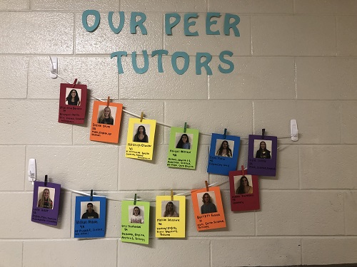PEER TUTORS PICTURES hang on hte wall outside of the new peer tutoring room, 107. Along with photos of each tutor, there is a brief bio complete with subjects they will tutor. 