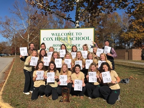 LADY FALCON FIELD hockey players hold signs up in front of the Home of over 50 state championships banner to display their 20th state championship win was also the 51st state title in the schools history.