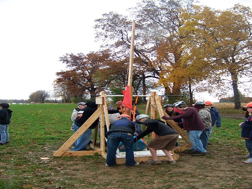 CONTESTANTS PREPARE TO launch their pumpkins. The group who launches their pumpkin the farthest is the winner.