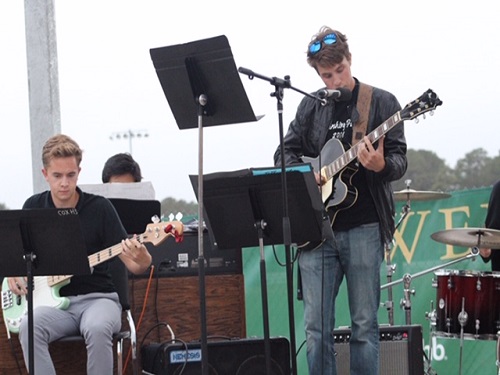 SENIOR BENJAMIN BECKER and Junior Edward Finman play the guitar for the opening celebration of the Wing. The band members have been preparing to play at the ribbon-cutting for weeks. 