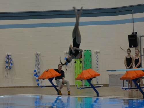 DIVE TEAM MEMBER completes a complicated maneuver during a meet.  The dive team competed  against high schools throughout Virginia Beach. 