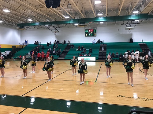THE LADY FALCON cheerleaders putting on a spirited show at halftime during the boys basketball game. The ladies shared court time with the Coquettes to get the crowds pumped up for the second half. 