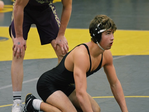 SENIOR DALTON LoALBO (152 lbs.) takes the mat in his defensive stance to continue his match. The Falcons competed in the Beach District tournament this past weekend. 