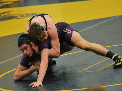 JUNIOR IAN BALIK (160 lbs.) dominates the mat against his competitor. The team fought hard against Tallwood at the tournament.