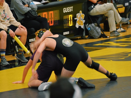 SOPHOMORE SHANE WHITNEY (195 lbs.) overshadows his opponent on the mat. The tournament took place at Kellam and included all VBCPS schools.