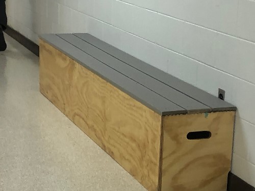 A WOODEN BENCH sits in the hallway. Benches crafted by Mr. Bouchs Tech. Ed. students worked diligently to build these benches from scratch. 