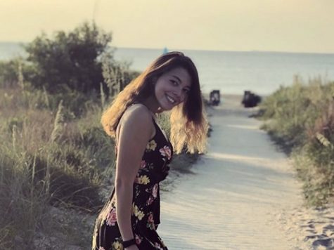 SENIOR HEIDI LEMOND poses on the beach. Heidi later shared her story of adapting to life in the United States with the Falcon Press. 