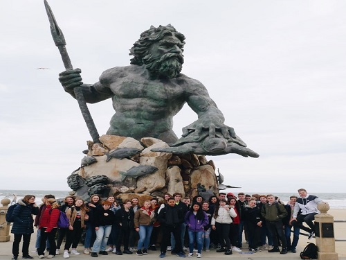 COX STUDENTS STAND in front of the King Neptune Statue at 31st street. This statue has symbolized the city of Virginia Beach for many years.