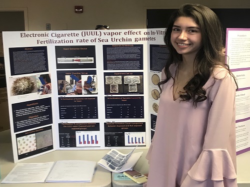 JUNIOR ALEX PEREZ presents her JUUL research to the panel of judges. Perez won first place in the Senior Division held at Old Dominions Webb Center.