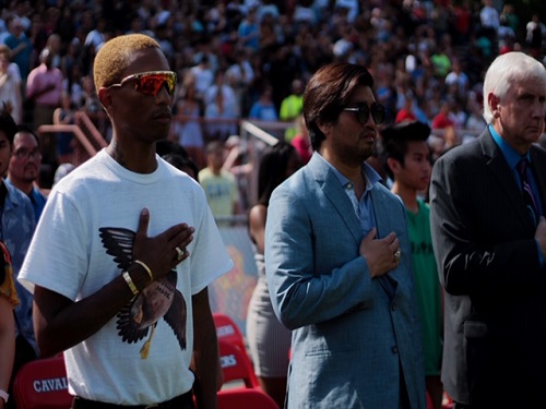 VIRGINIA BEACH CITY public school alumni Pharrell Williams and Chad Hugo cover their hearts during the playing of the national anthem. Williams and Hugo decided to start a annual music festival in Virginia Beach to showcase how amazing the city is. 