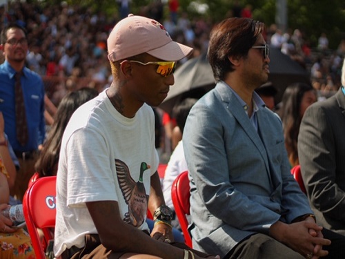 CELEBRITIES PHARRELL WILLIAMS and Chad Hugo watch the Battle of the Band in the Princess Anne High School Stadium on Wednesday, April 24. The band programs from all Virginia Beach schools were given the opportunity to preform. 