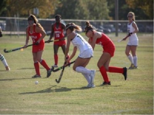 SOPHOMORE EMA CHRISTIAN defends the ball from attacking players during a field hockey game at Cox on September 10. The Falcons were defending a number one seed position.