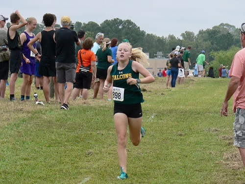 FRESHMAN BELLA CLARK sprints to the finish. Clark was the Falcons frontrunner at the invitational.