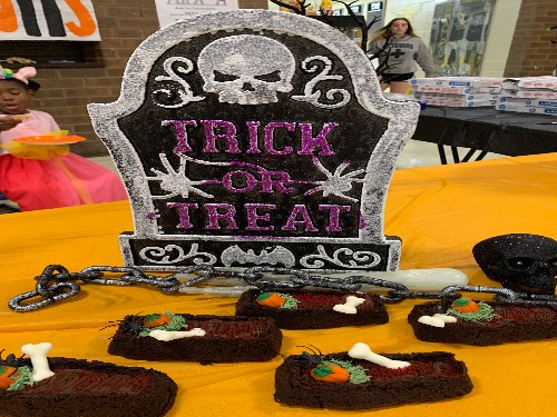 CUP CAKE WARS offer children attending Boo Bash the opportunity to decorate their own cupcakes. The trick-or treat display (above) was created by Goodmans Culinary class as inspiration.