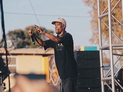 RAPPER TRAVIS SCOTT points to his audience during a concert. "I don't need a stage to perform, just something to stand on," Travis Scott said.