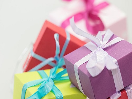 COLORFUL HOLIDAY GIFTS are arranged in a pile. They were do it yourself presents made for family members.
