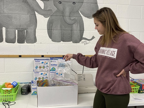 SENIOR KAITLYN PISTON donates a clean plastic lunch bag to help the school win the Nex Trex Recycling Challenge. At the end of the challenge the sailing club will personally deliver all of the donations to the drop off station.  