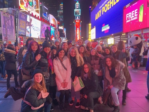 New York Citys Times Square plays host to museums, galleries and theaters, as well as the opportunity to see the bright neon lights at night. Art teacher Mrs. Van Veenhuyzen (center) and her students surround themselves in the citys diverse culture.
