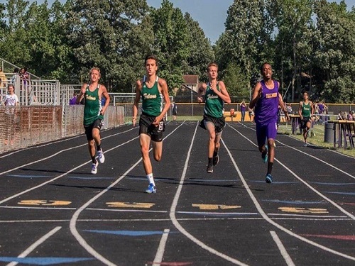 SENIOR JOSH WARMERS (middle left) competes in a track meet against Tallwood High School. He claimed his motivation for running was his mother.