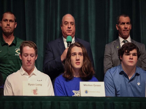 FUTURE COLLEGIATE ATHLETES listen intently as Varsity Lacrosse coach Todd Esposito speaks proudly about his students. Senior Weston Green commited to Limestone University to play lacrosse and further his education