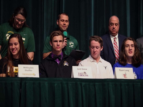FUTURE COLLEGIATE ATHLETES listen intently as baseball coach Robert Ittner speaks proudly about his students. Senior students Ryan Long and Josh Grubz commited to their respective universities,  Lynchburg  and East Carolina, to further their academic and athletic careers. 