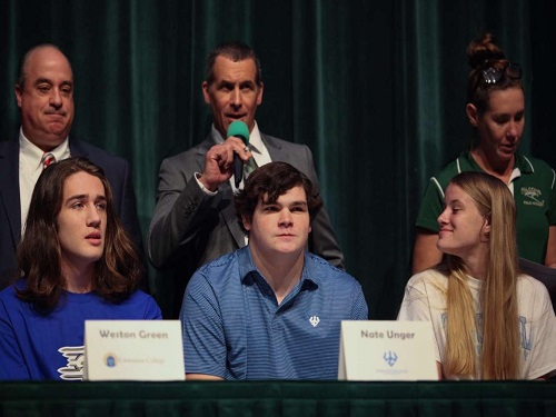 SENIOR NATE UNGER (center front) sits stoically while his football coach Bill Stachelski (center back) speaks about his work ethic and character during National Signing Day. Unger ultimately chose to venture into higher education. for both academics and football. at Washington & Lee University in the fall.
