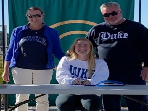 SENIOR ABBY SPEAR signs her Letter of Intent to play field hockey for Duke University in the fall. Spears parents were in the Wing to support her during the ceremony. 
